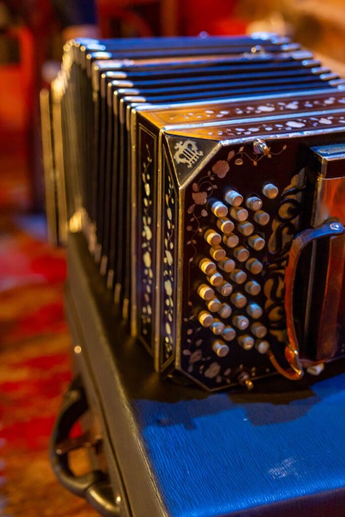 Close-up of a traditional bandoneón accordion with ornate details, set in warm lighting.
